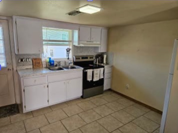 348 Tarpon Avenue Fernandina Beach, FL 32034 - Photo 12 of 44 a kitchen with stainless steel appliances granite countertop a stove a sink and a refrigerator