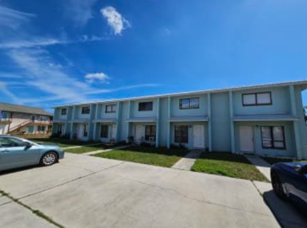 348 Tarpon Avenue Fernandina Beach, FL 32034 - Photo 2 of 44 a view of brick building with a yard
