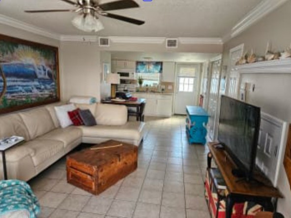 348 Tarpon Avenue Fernandina Beach, FL 32034 - Photo 4 of 44 a living room with furniture a flat screen tv and a fireplace