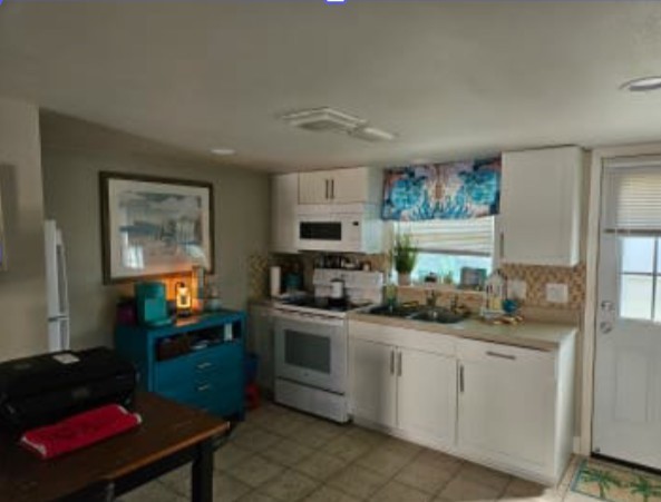 348 Tarpon Avenue Fernandina Beach, FL 32034 - Photo 5 of 44 a kitchen with stainless steel appliances granite countertop a sink stove and cabinets