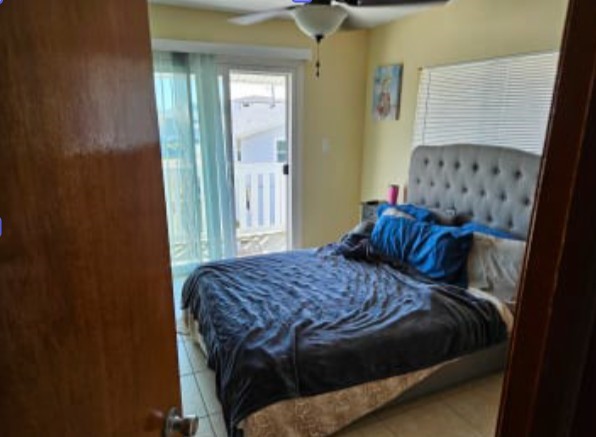 348 Tarpon Avenue Fernandina Beach, FL 32034 - Photo 9 of 44 a bedroom with a bed and a window