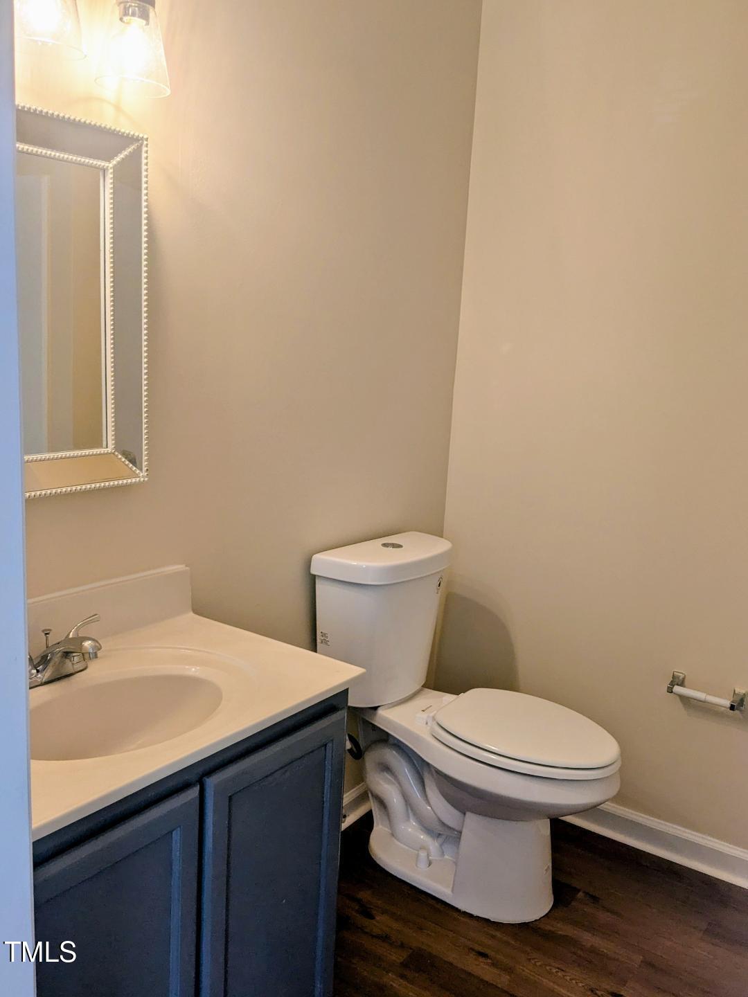 1911 Wolf Tech Lane, Unit 204C Raleigh, NC 27603 - Photo 12 of 18 a white toilet sitting next to a bathroom sink
