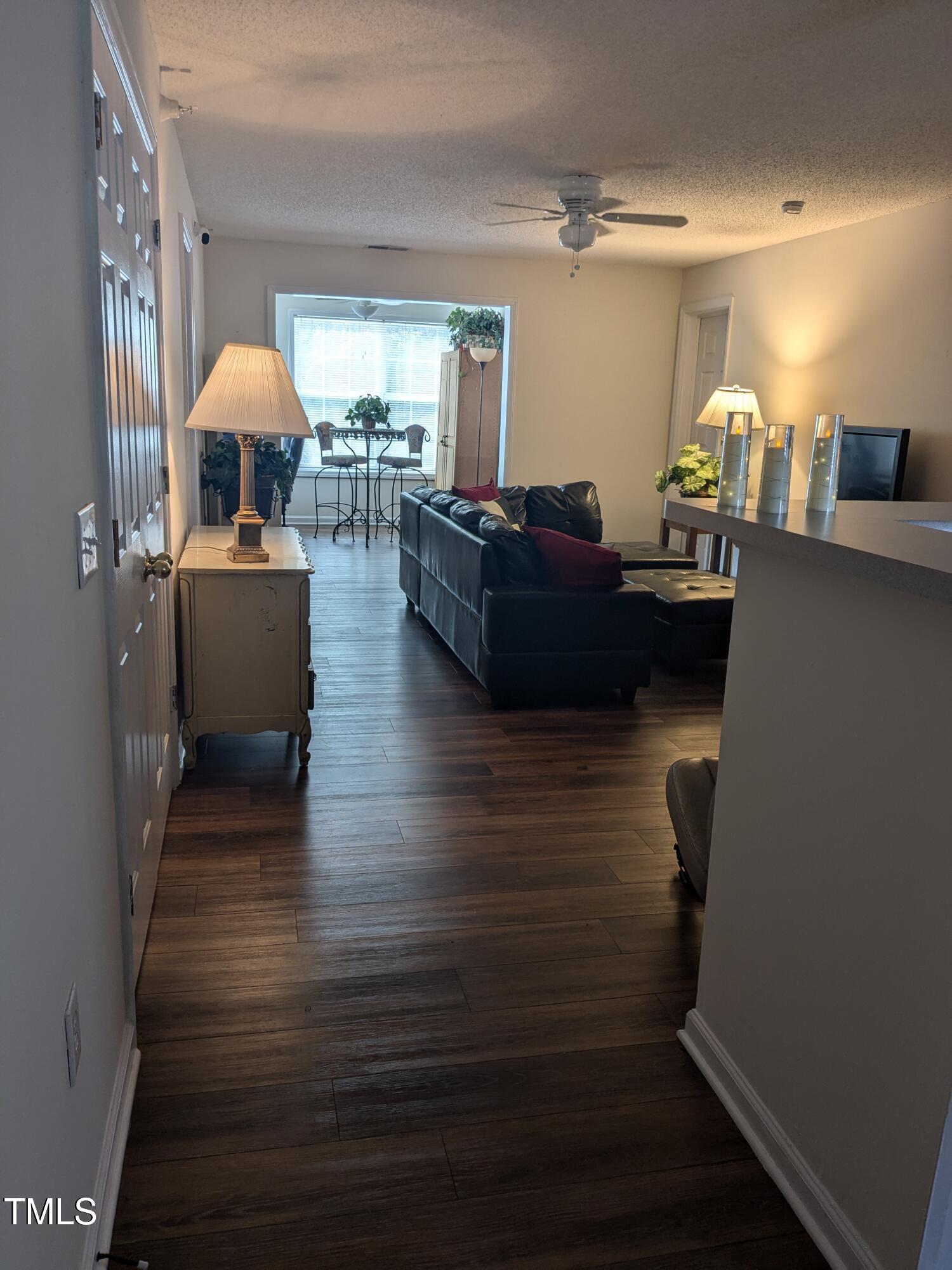 1911 Wolf Tech Lane, Unit 204C Raleigh, NC 27603 - Photo 8 of 18 a living room with furniture and a wooden floor