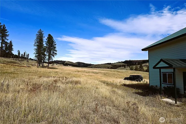 a backyard of a house with table and chairs