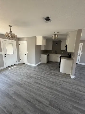 a view of a kitchen with a sink and a refrigerator