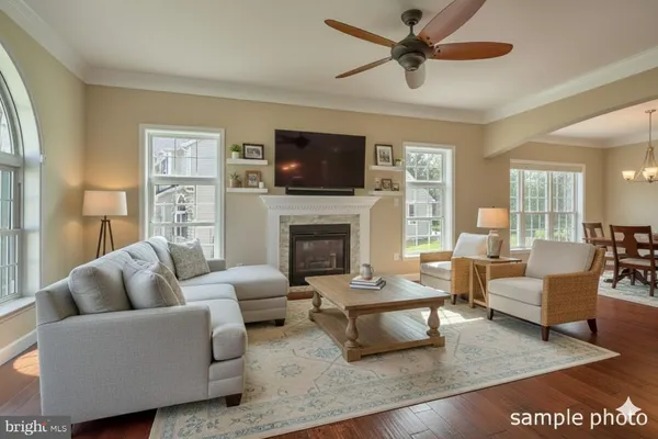 a kitchen with stainless steel appliances granite countertop a refrigerator a stove a sink dishwasher and white cabinets with wooden floor