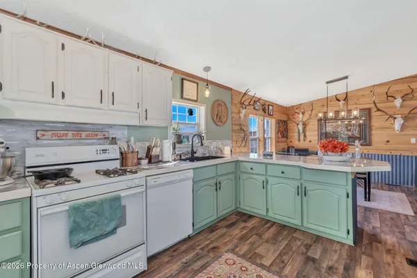 a kitchen with stainless steel appliances granite countertop a sink and cabinets