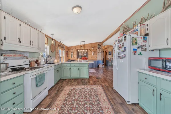 a kitchen with cabinets a sink and appliances