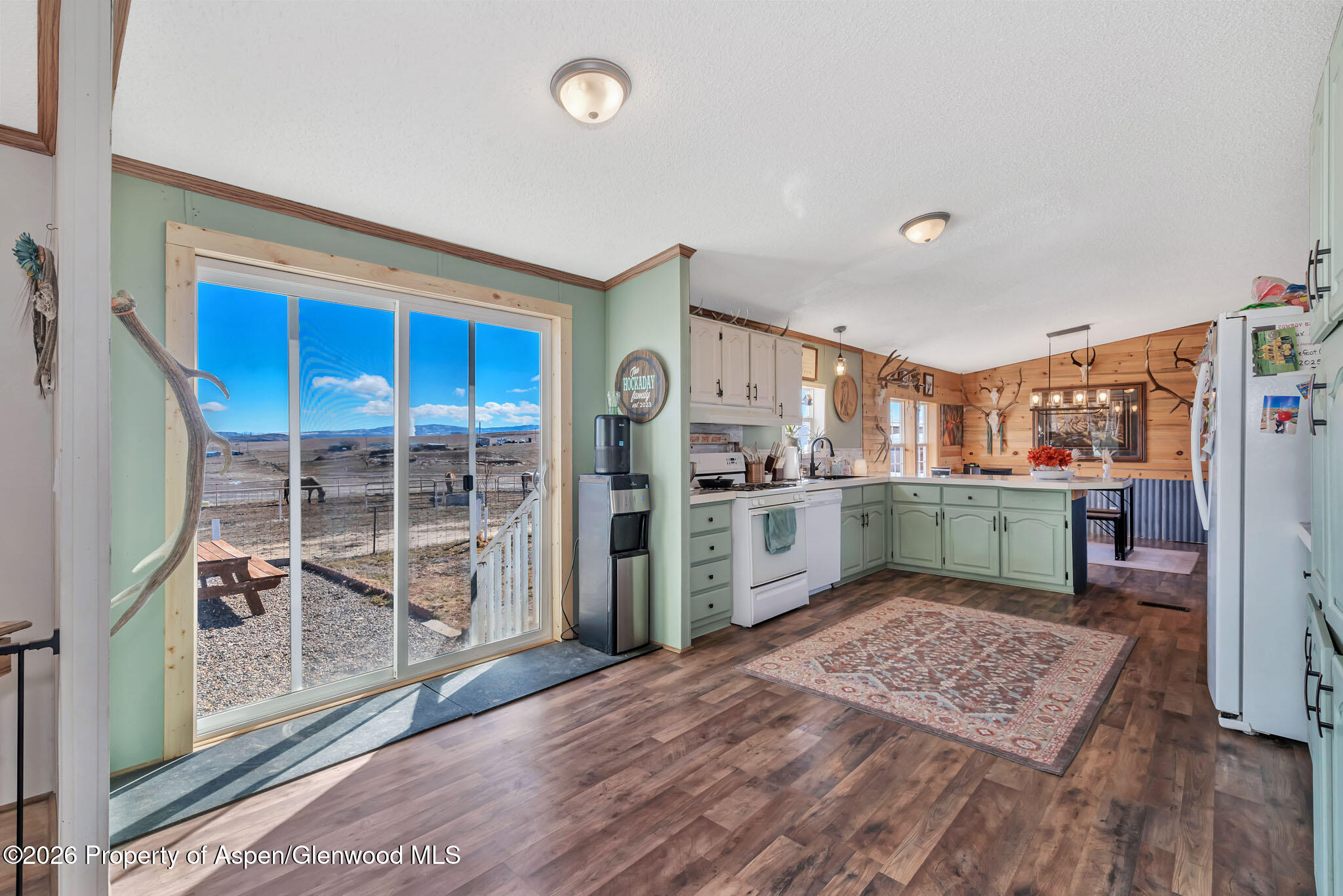 275 Roberts Road Craig, CO 81625 - Photo 18 of 47 a view of a kitchen with fridge and wooden floor