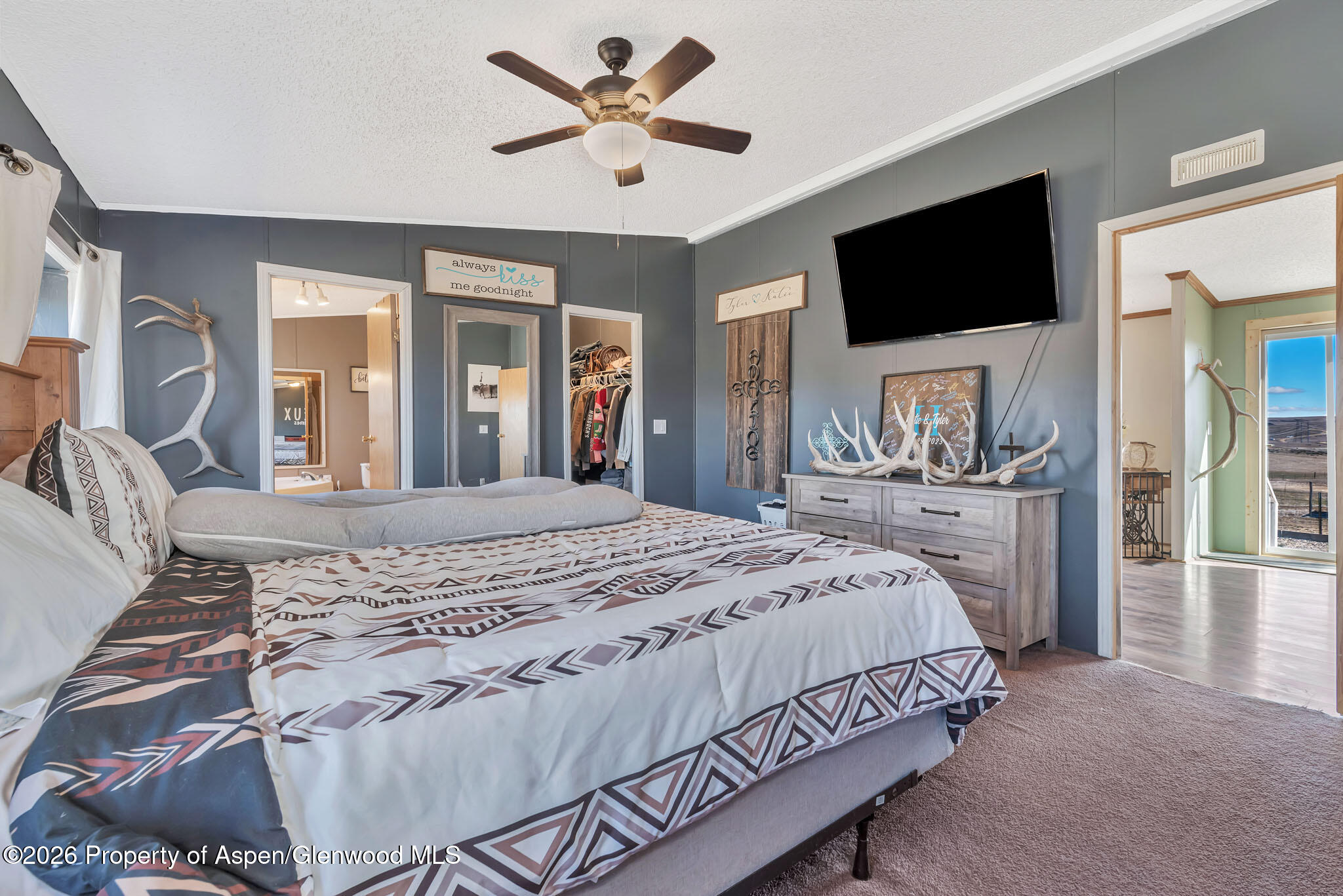 275 Roberts Road Craig, CO 81625 - Photo 21 of 47 a spacious bedroom with a bed and a flat screen tv