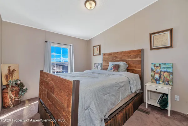 a bed room with a bed and a chair