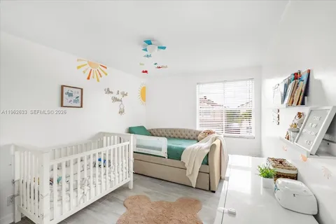 a bedroom with furniture and a large window