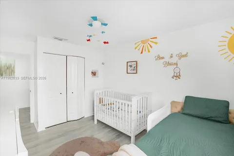a bedroom with a bed and wooden floor
