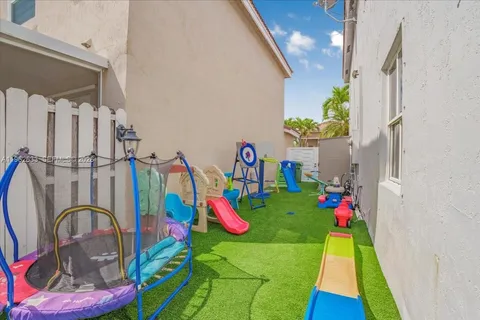 a living room with a baby crib furniture and a chandelier