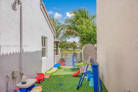 a baby room with toys and a potted plant