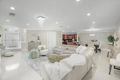 a living room with furniture and a view of bathroom
