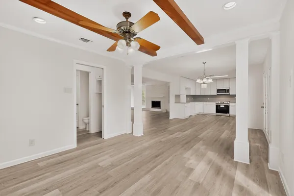 a kitchen with granite countertop white cabinets and appliances