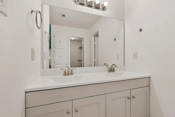 a view of a kitchen with a sink and cabinet