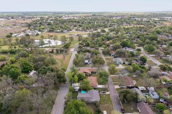 an aerial view of a houses with yard