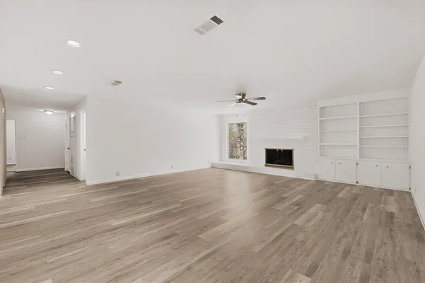a view of a kitchen with a sink dishwasher a stove top oven and cabinets