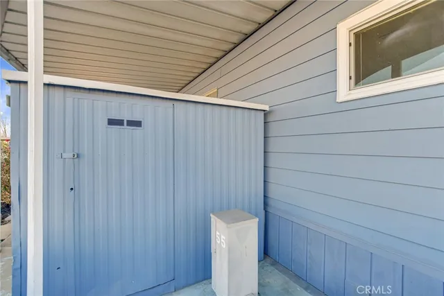 a yellow house with tree in front of it