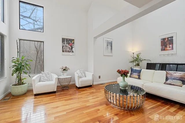 a living room with furniture and flowers