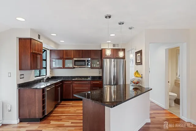 a kitchen with stainless steel appliances a sink and a refrigerator
