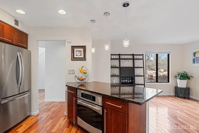 a kitchen with stainless steel appliances granite countertop a refrigerator and a sink