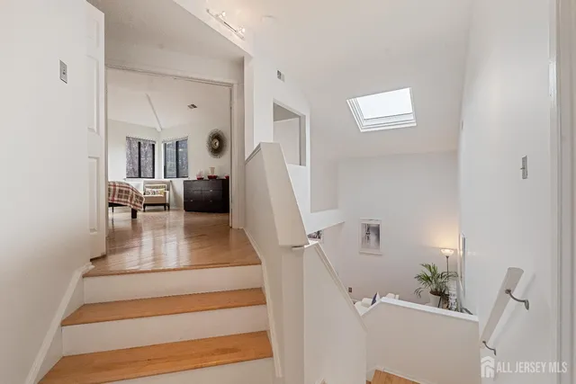 a view of living room with furniture and a clock