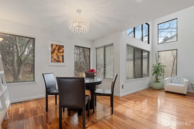 a view of a dining room with furniture window and wooden floor