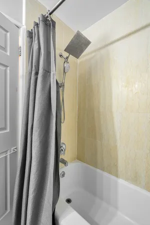 a bathroom with a shower and a tub