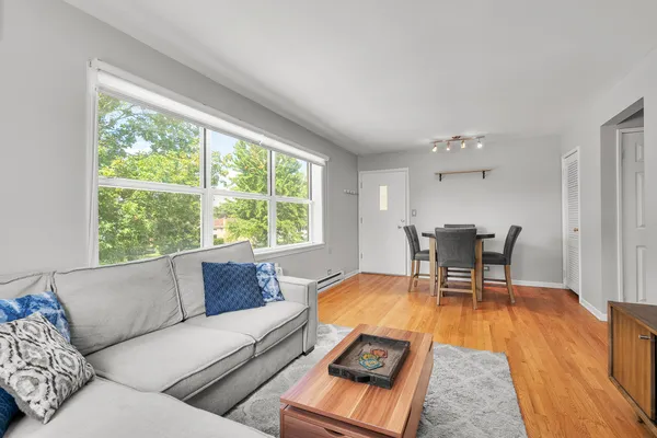 a living room with furniture and a wooden floor