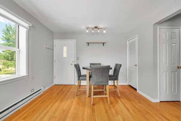 a view of a dining room with furniture and wooden floor