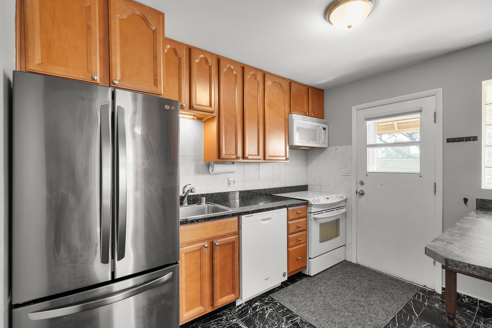 1415 Homestead Road, Unit 8 La Grange Park, IL 60526 - Photo 8 of 16 a kitchen with stainless steel appliances granite countertop a refrigerator a sink a stove and white cabinets