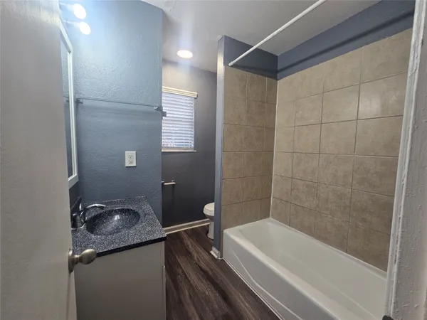 a bathroom with a bathtub and a sink