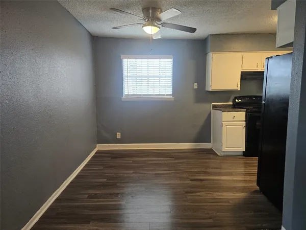 a view of a kitchen with a sink refrigerator and wooden floor