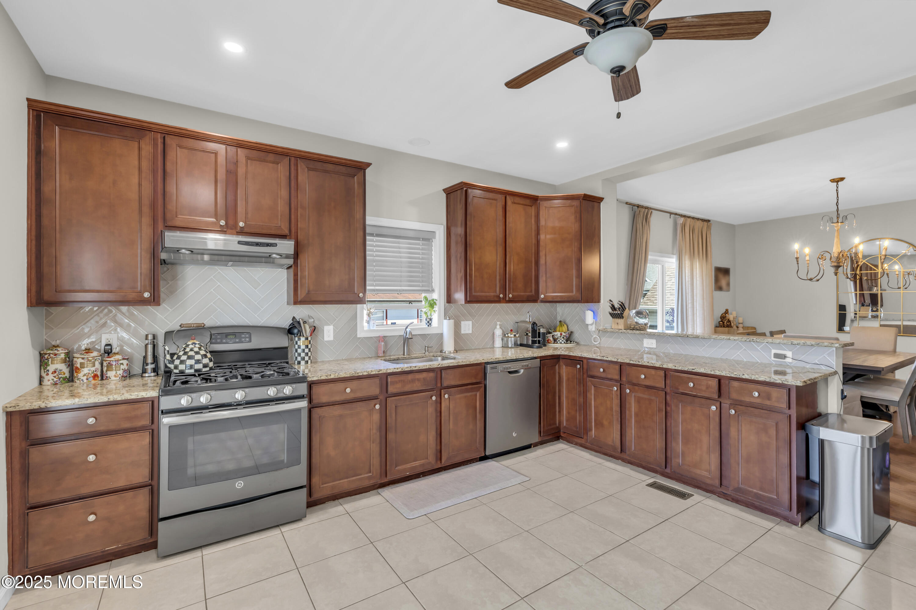 31 Ocean Avenue Middletown, NJ 07748 - Photo 15 of 39 a kitchen with stainless steel appliances granite countertop a stove sink and cabinets