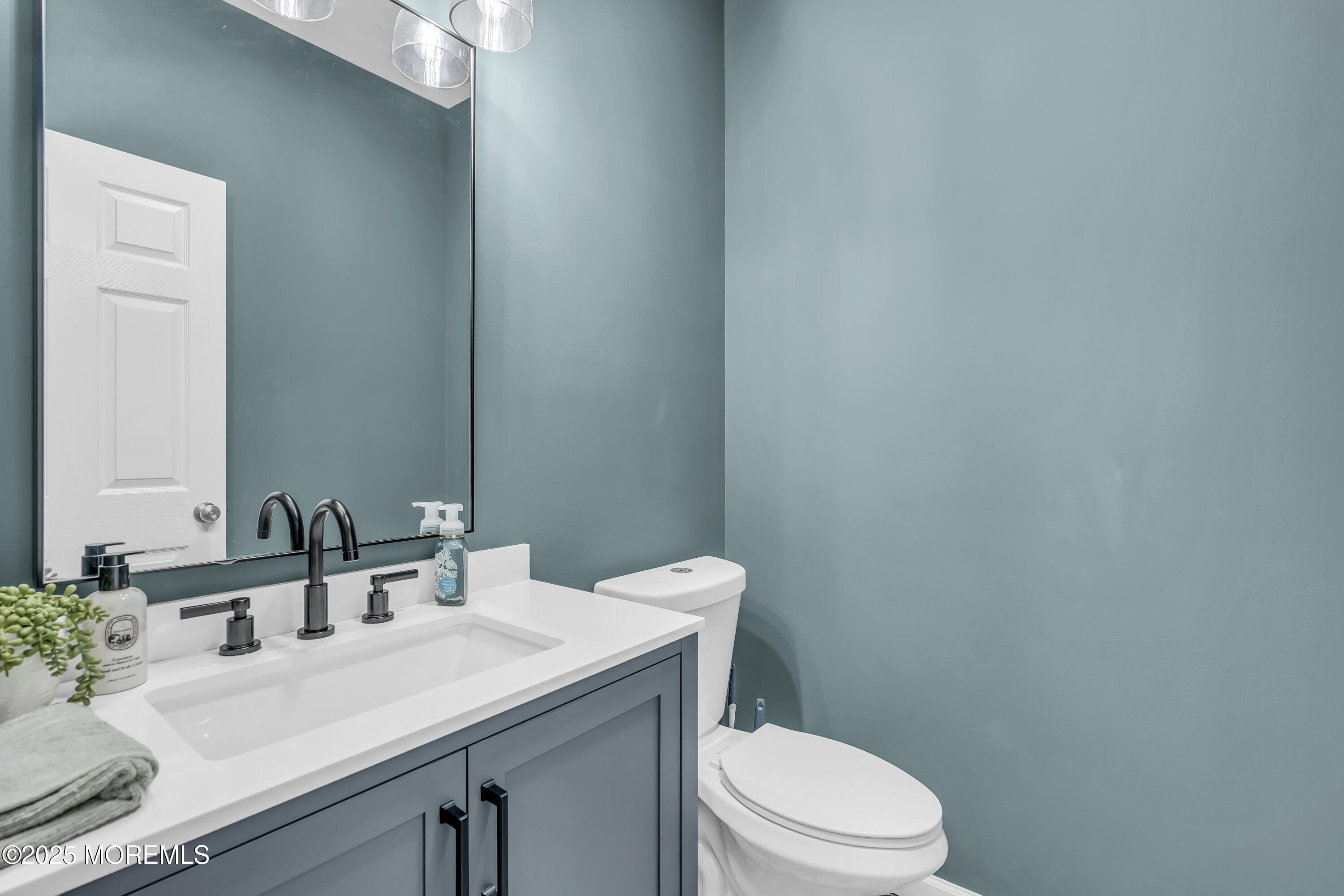 31 Ocean Avenue Middletown, NJ 07748 - Photo 20 of 39 a bathroom with a granite countertop sink vanity mirror and toilet