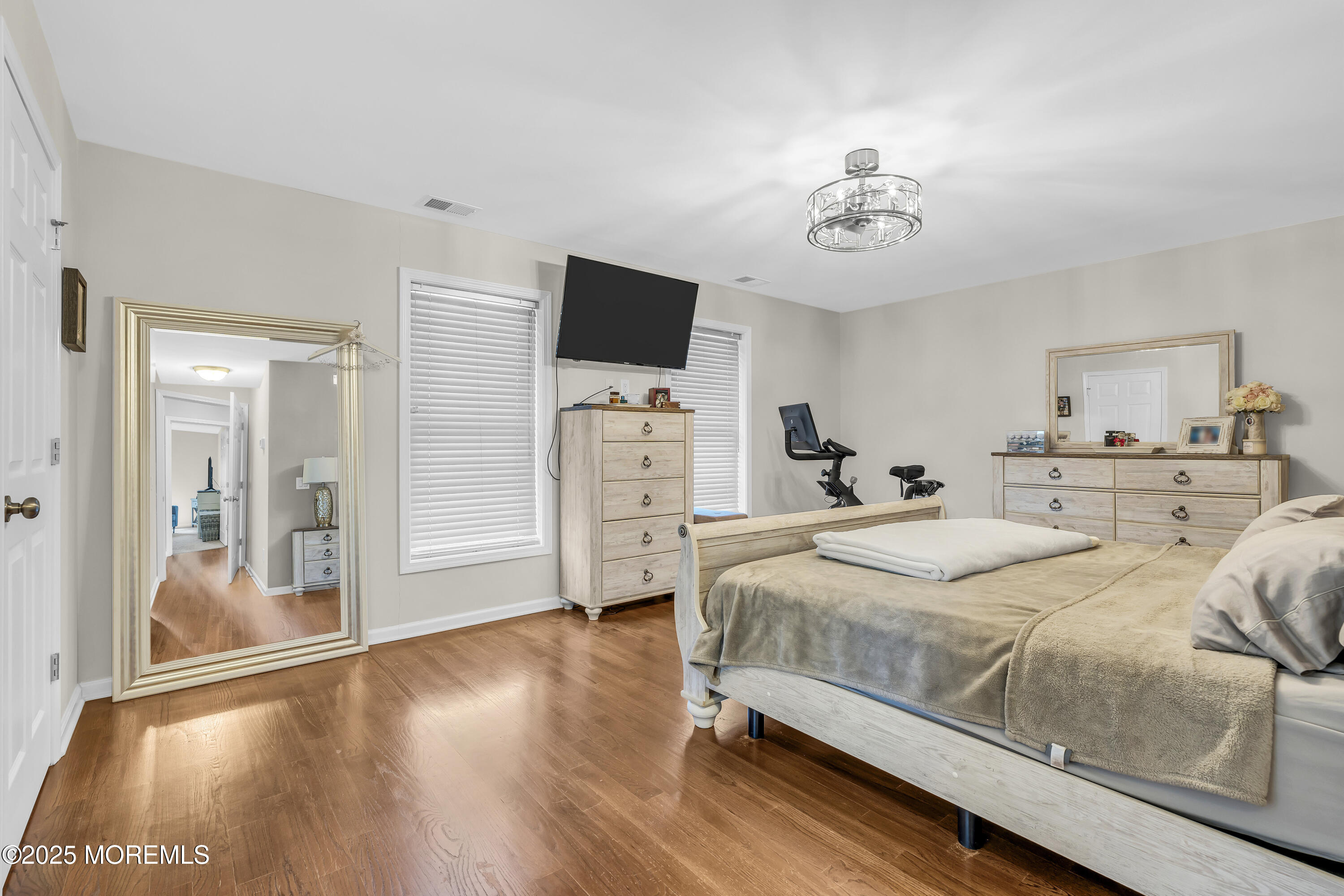 31 Ocean Avenue Middletown, NJ 07748 - Photo 23 of 39 a bedroom with a bed and a flat tv screen on dresser