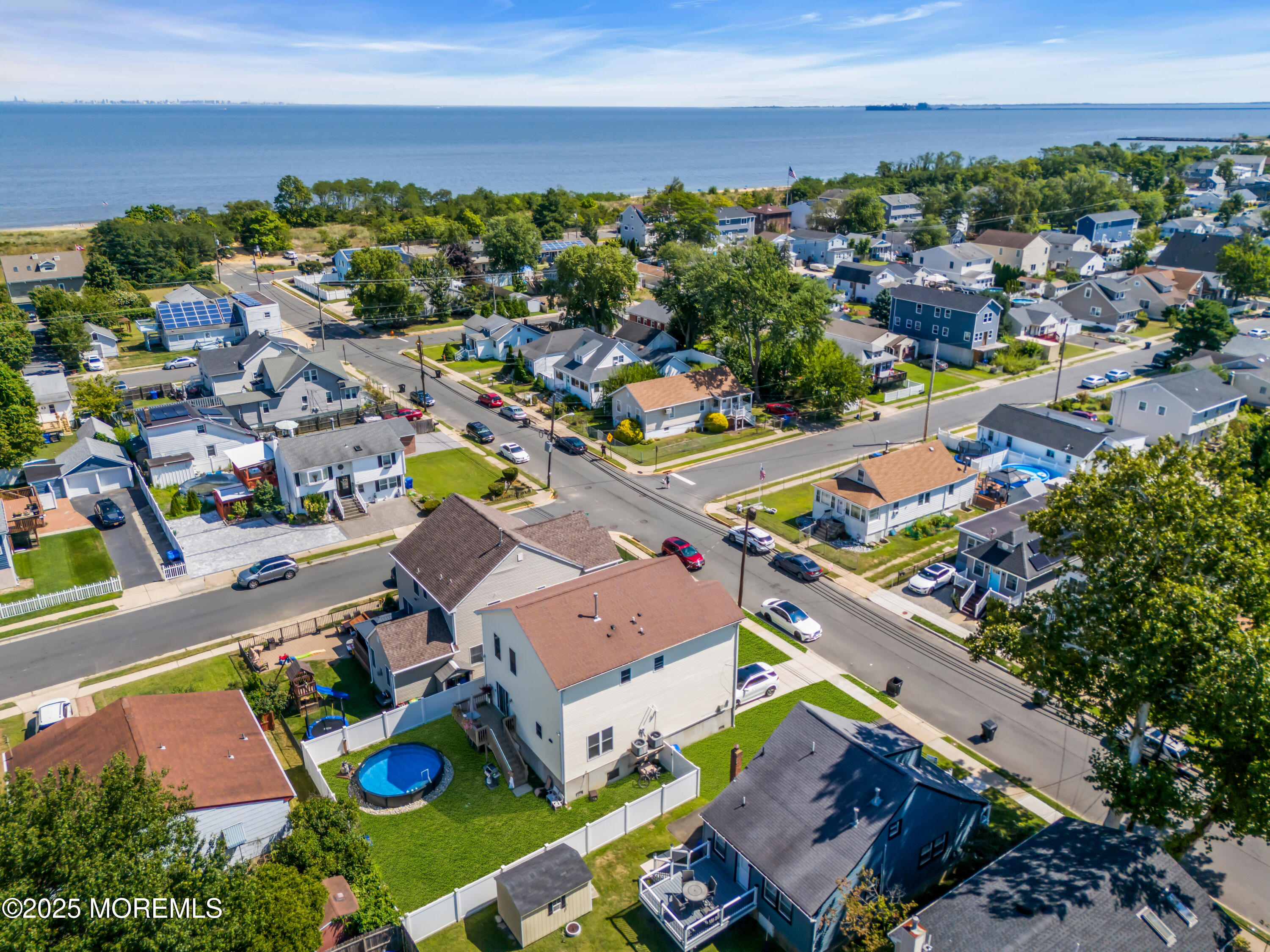 31 Ocean Avenue Middletown, NJ 07748 - Photo 4 of 39 an aerial view of a city with lots of residential buildings and ocean view in back