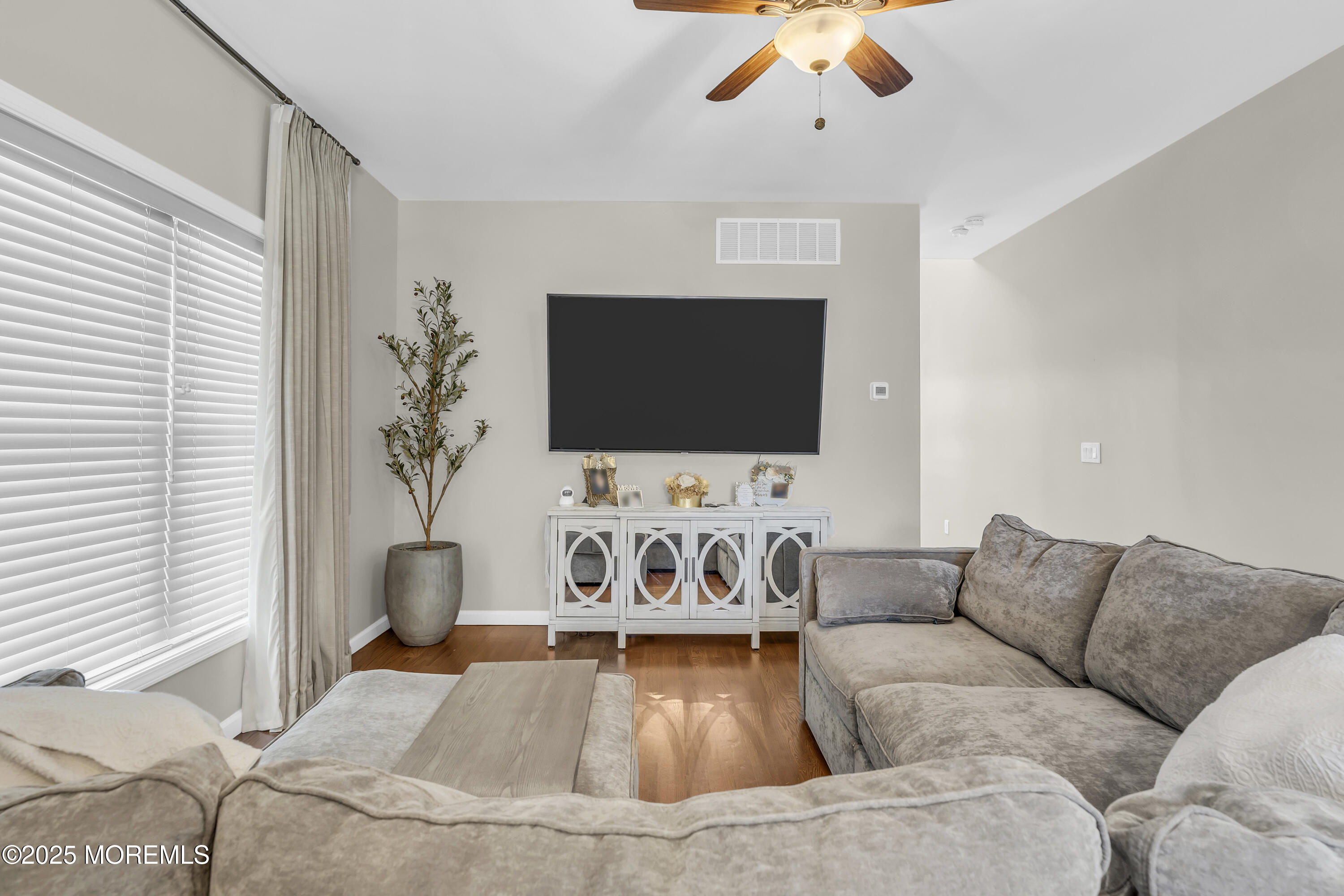31 Ocean Avenue Middletown, NJ 07748 - Photo 10 of 39 a living room with furniture and a flat screen tv
