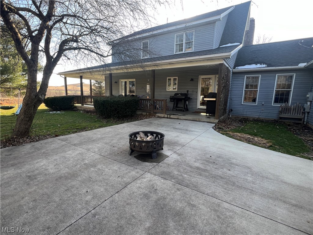 4512 Tabor Ridge Road Northeast Mineral City, OH 44656 - Photo 38 of 44 View of front of property featuring a porch and an outdoor fire pit