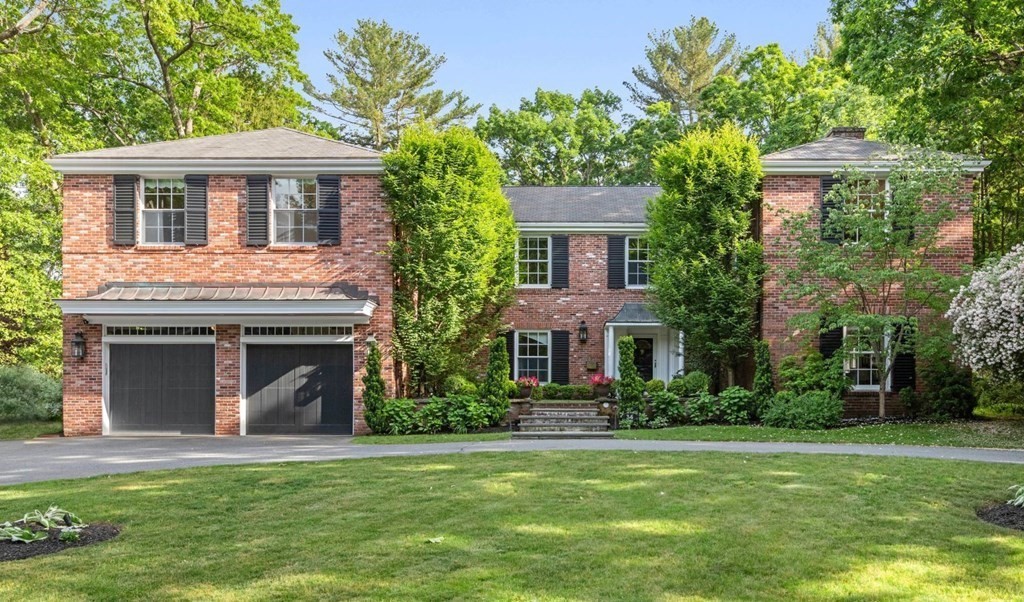 36 Audubon Road Wellesley, MA 02481 - Photo 1 of 40 a front view of a house with a garden and trees