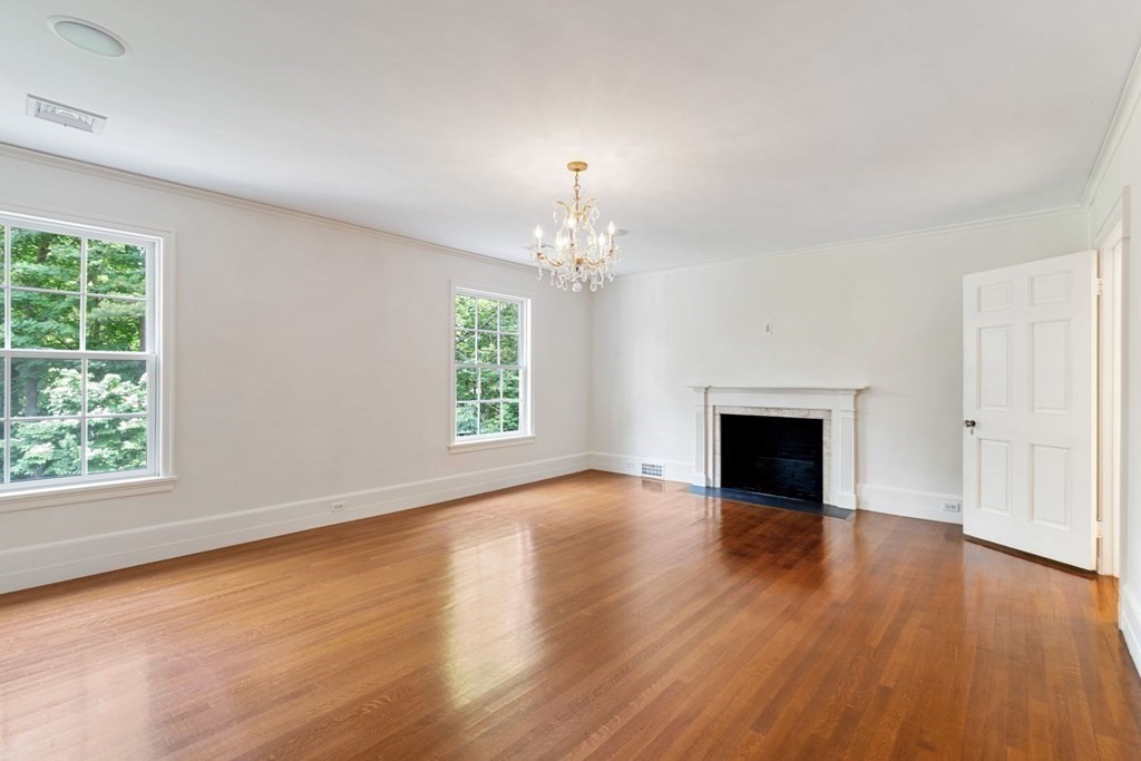 36 Audubon Road Wellesley, MA 02481 - Photo 30 of 40 an empty room with wooden floor fireplace and windows