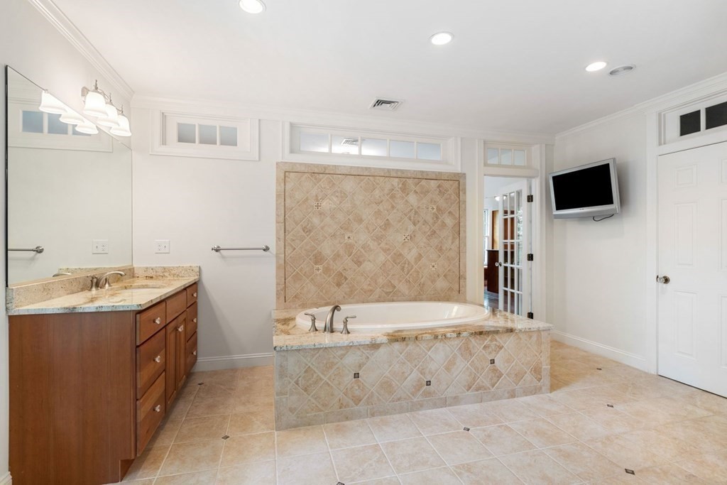 36 Audubon Road Wellesley, MA 02481 - Photo 33 of 40 a spacious bathroom with a tub a sink and mirror