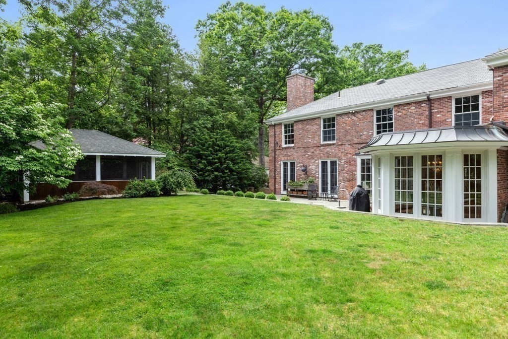 36 Audubon Road Wellesley, MA 02481 - Photo 39 of 40 a front view of a house with a garden