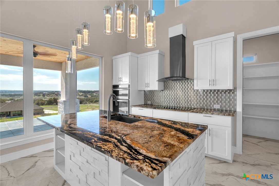 142 Wizard Way Spring Branch, TX 78070 - Photo 12 of 48 a kitchen with kitchen island granite countertop a sink and a stove