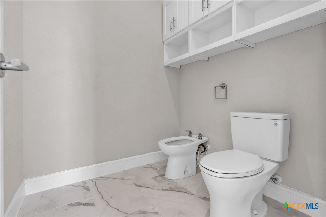 142 Wizard Way Spring Branch, TX 78070 - Photo 26 of 48 a white toilet sitting next to a white sink