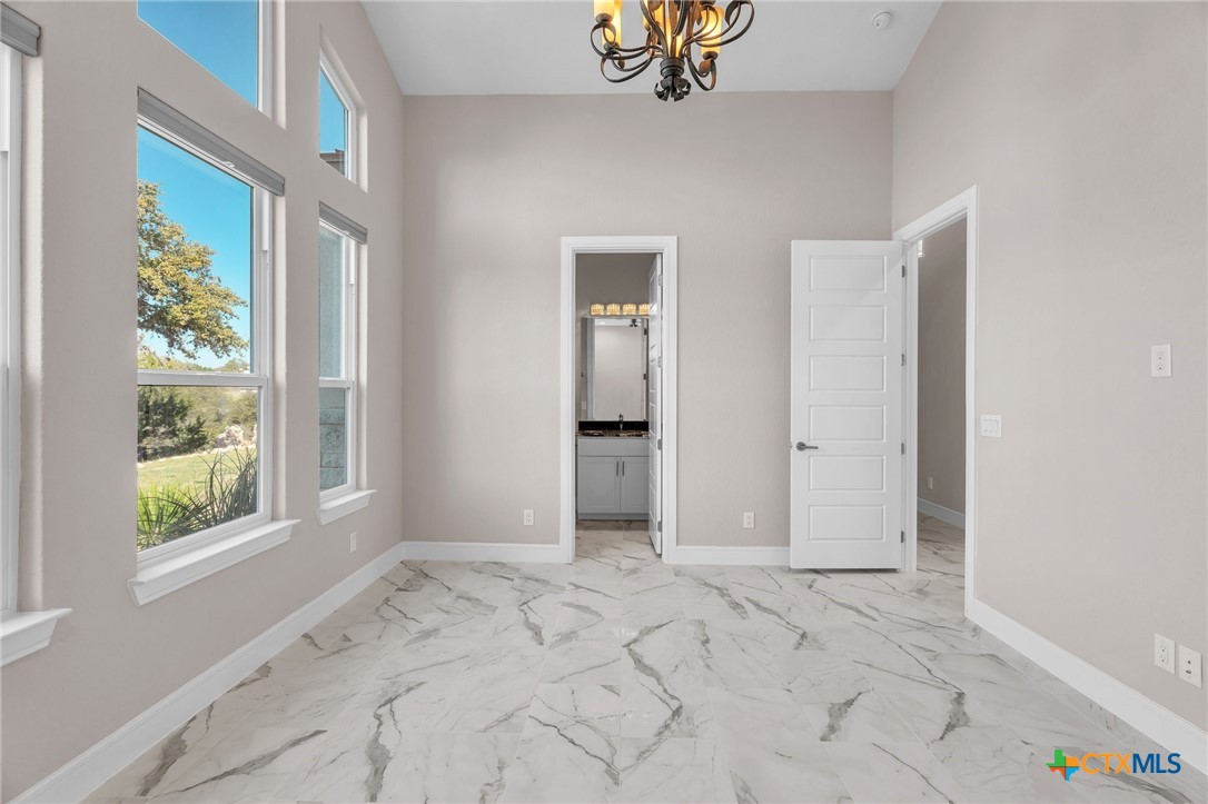 142 Wizard Way Spring Branch, TX 78070 - Photo 31 of 48 a view of an empty room with window and chandelier fan