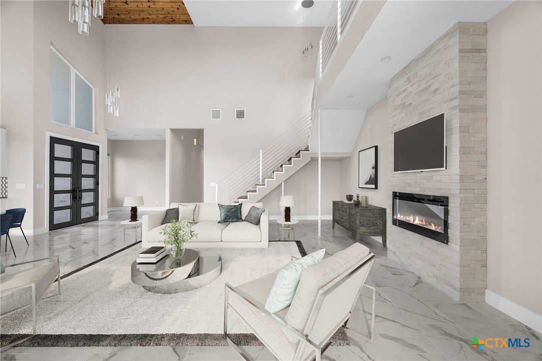 142 Wizard Way Spring Branch, TX 78070 - Photo 7 of 48 a living room with furniture a fireplace and a flat screen tv